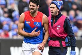 Christian Petracca tried to play on after suffering a rib injury, but eventually left the field. (James Ross/AAP PHOTOS)